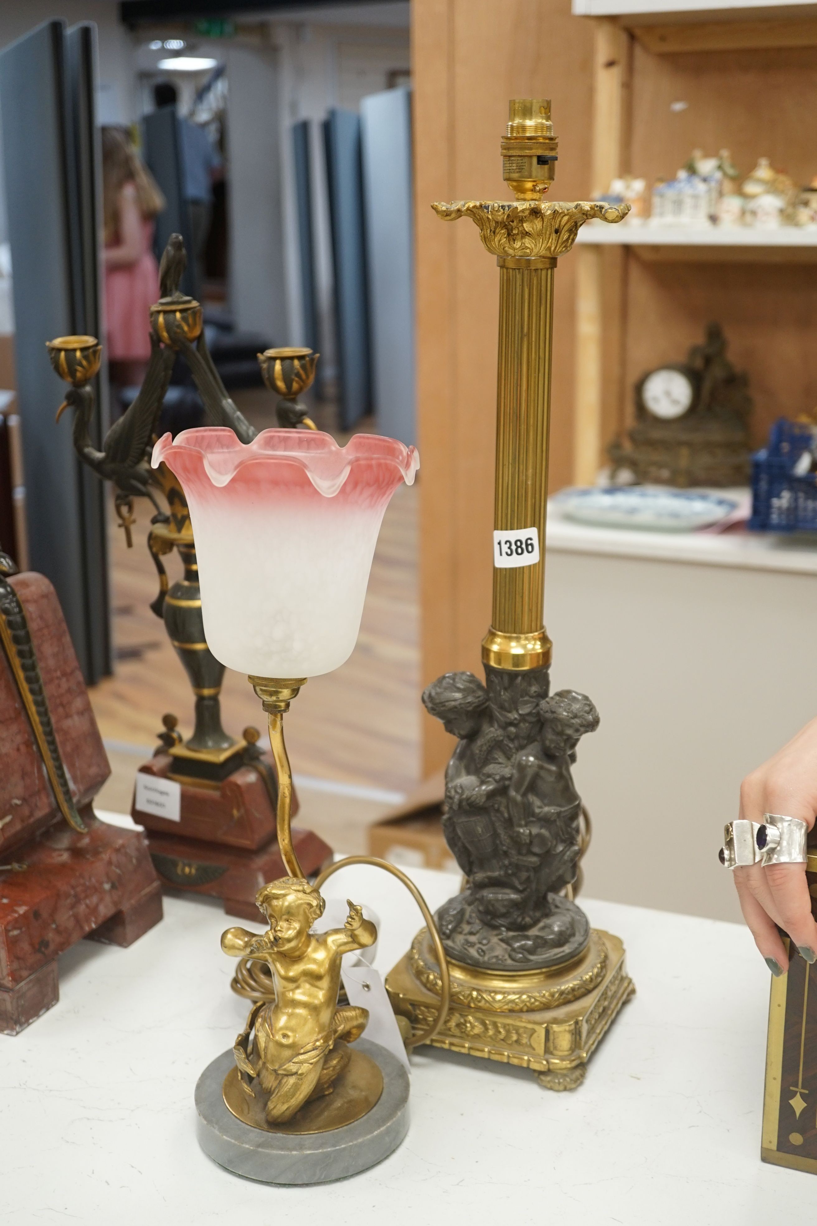 Two bronze or ormolu cherubic table lamps, one with shade. Tallest 58cm total